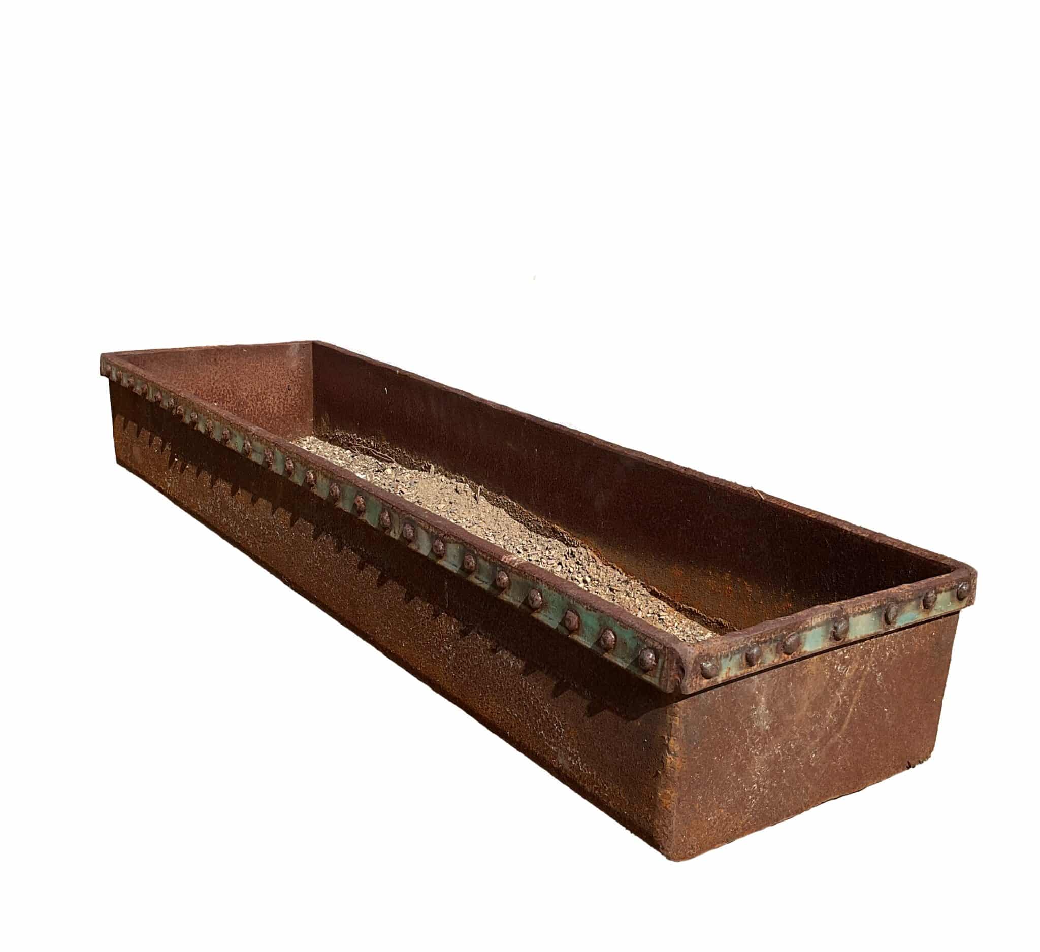 Long rectangular rusted steel trough planter with riveted rim edging