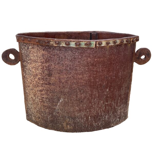 Wide oval up-cycled metal planter with a riveted rim band, circular loop handles on each side, and a rust patina finish
