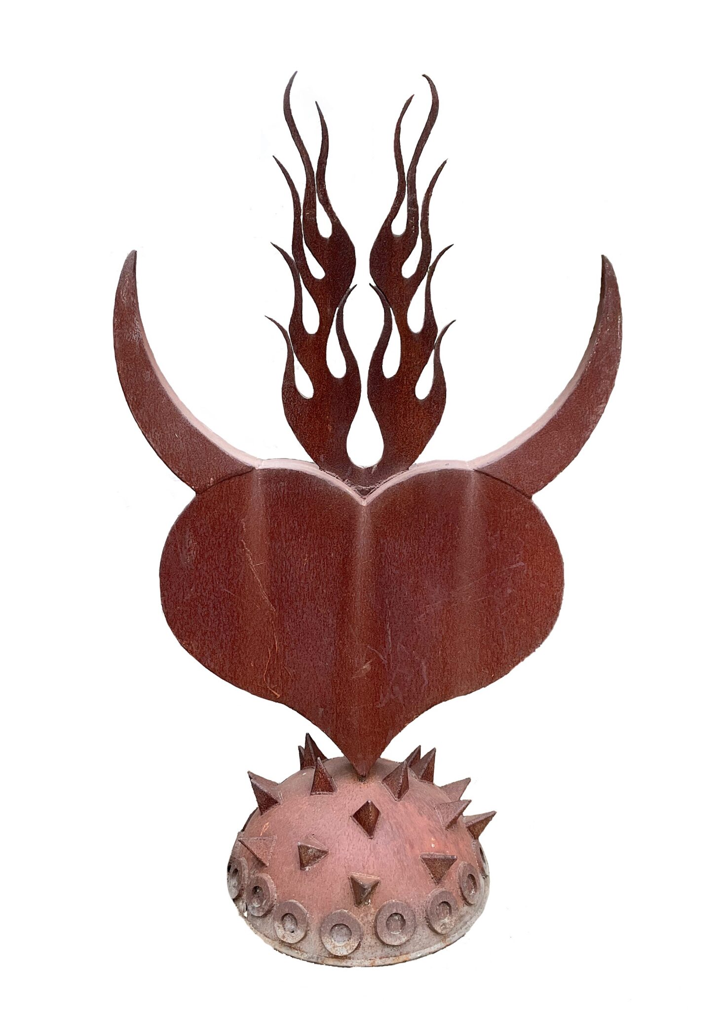 Rusted steel heart sculpture with curved horns and flame details rising from the top, mounted on a spiked spherical base