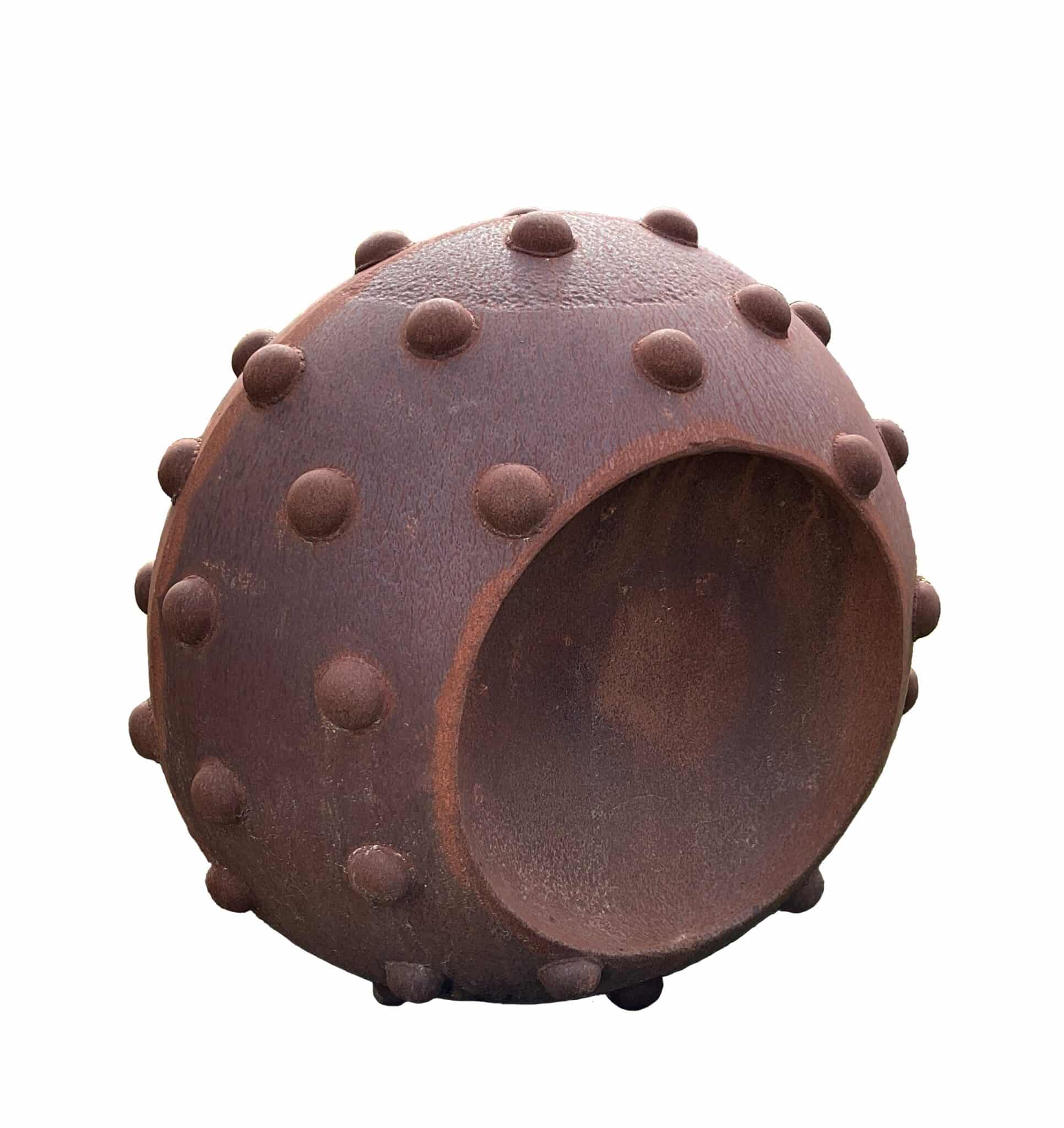 Spherical rusted steel sculpture with rounded knob-like studs covering the surface and a cylindrical opening on one side
