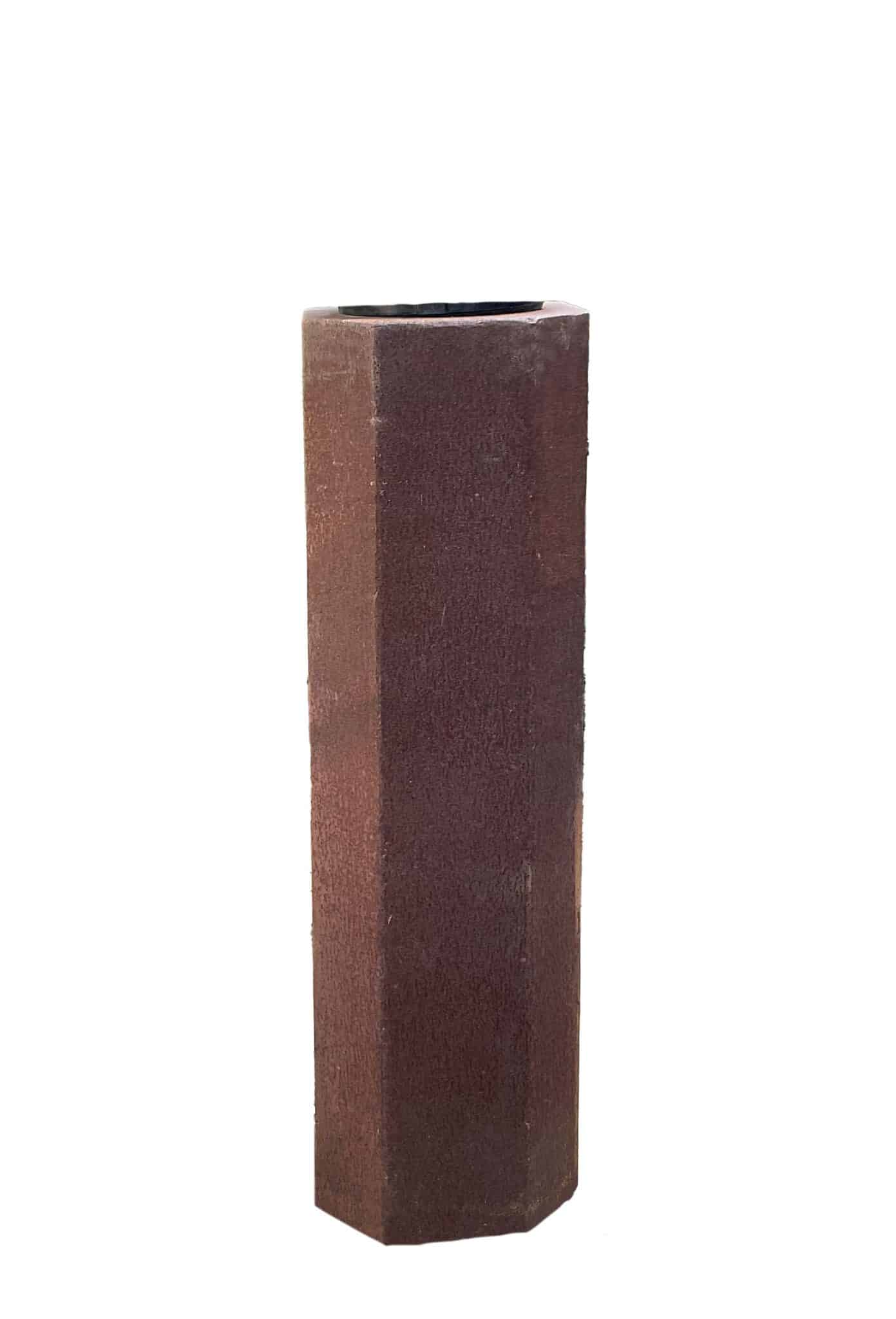 Tall octagonal rusted steel pedestal column with a flat base