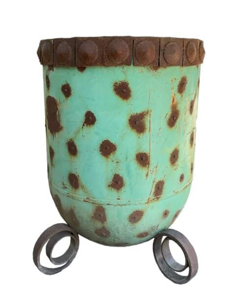 Tall up-cycled metal planter with a weathered turquoise patina and scattered rust spots, set on ring-shaped feet