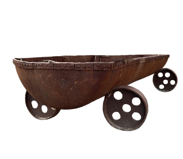 Boat-shaped rusted steel planter with riveted rim and four large perforated wheel-like feet